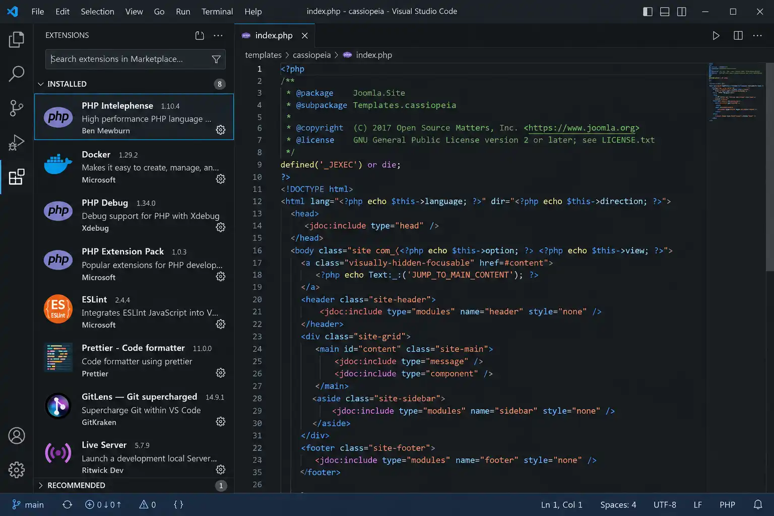VS Code editing a PHP theme file with PHP Intelephense and Docker extensions visible in the sidebar